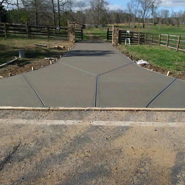 Finished concrete driveway entrance with stone columns